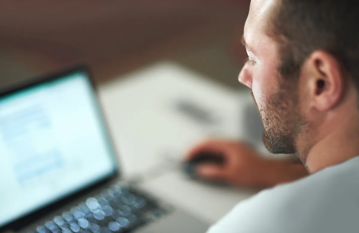 Person reviewing information on a laptop