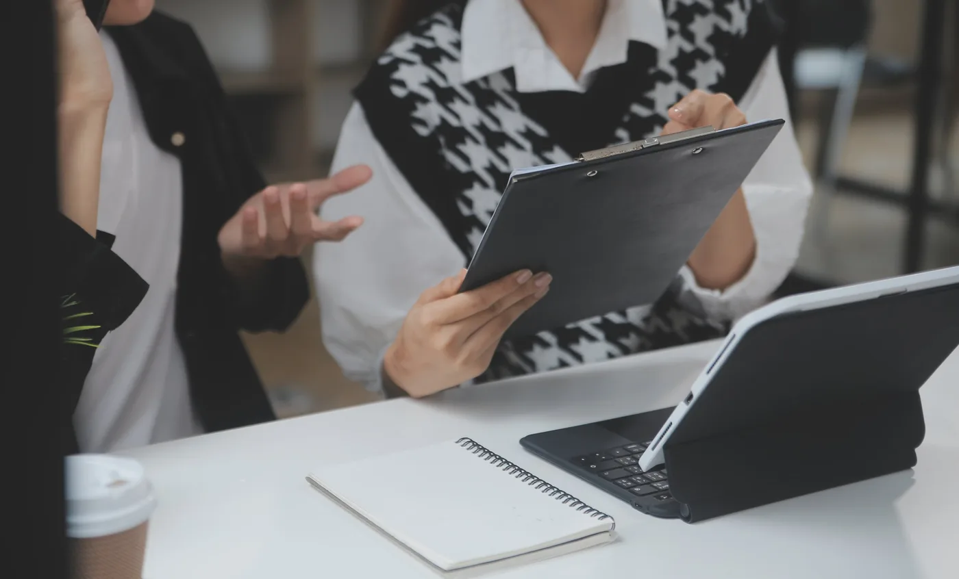 Two people reviewing a sales proposal in a work meeting
